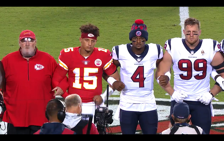 Players and coaches from the Chiefs and Texans link arms at center field