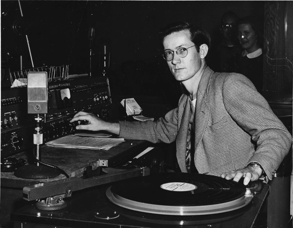Francis as a DJ, spinning disks at the local radio station