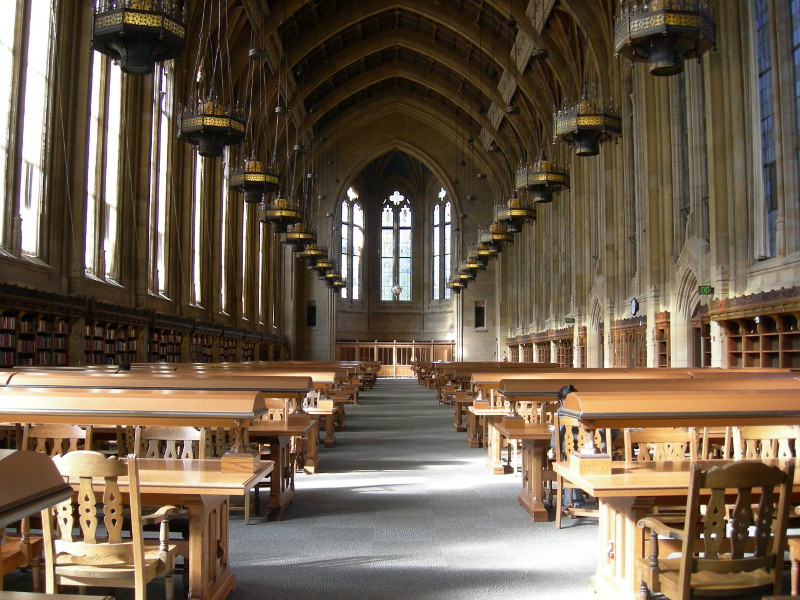 photo of the Suzzallo Library interior, featuring towering ceilings and ornate trim